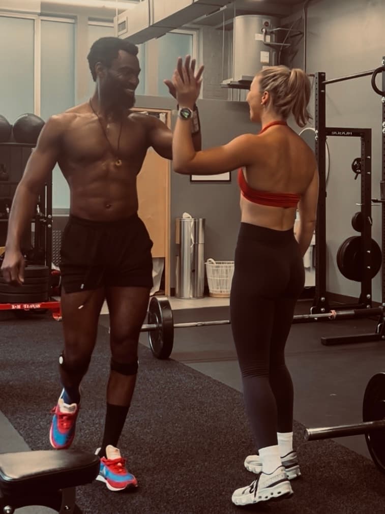 Two people high-fiving after a workout
